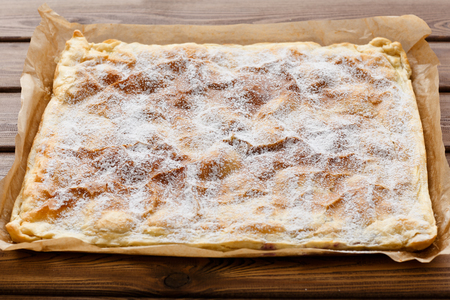 A view of 45 degrees angel at a sweet puff cake on a wooden table.の写真素材