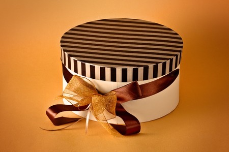 Brown gift isolated on orange background