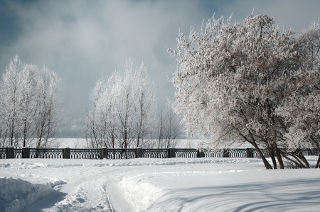 winter landscape with road  on the riverside