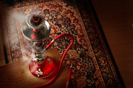 Hookah in smoke over a asian carpet