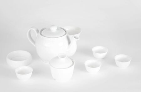 A picture of plain white china teapot and cupsの写真素材