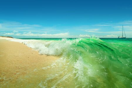 A sea landscape with turquoise waves and yachtの写真素材