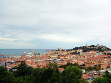 View of the harbor in the Italian city of Ancona. Historic architecture and trees are visible in the foregroundの写真素材