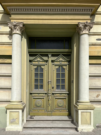 Entrance portal of historicist architectural building with beautiful neo-baroque door, Latvia, Europeの写真素材