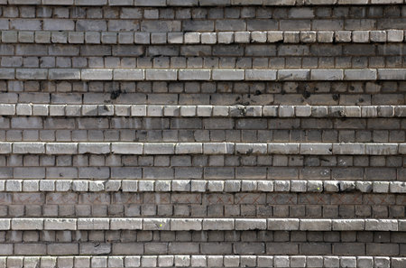 Weathered brick steps arranged in offset horizontal rows, showcasing texture, pattern, and...