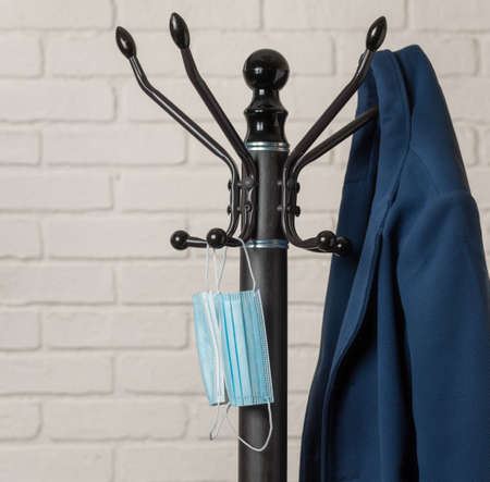 I returned home, hung my coat and a sanitary mask on a hanger. Mask on a hanger in the hallway....