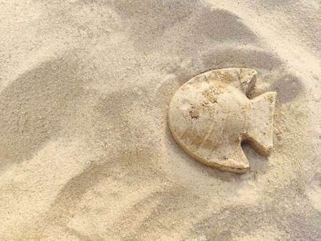 The figure of a fish made of sand. Close-upの写真素材