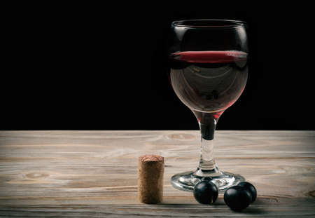 glass of red wine and bottle of wine
