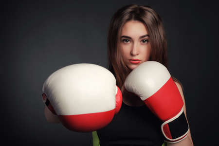 beautiful woman with the red boxing gloves,black background artの写真素材