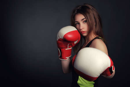 beautiful woman with the red boxing gloves,black background artの写真素材