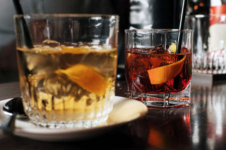 Two glasses of cocktail with orange slice. Toned imageの写真素材