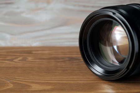 camera photo lens on old wooden tableの写真素材