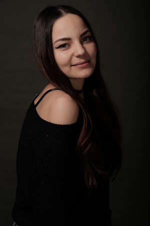 Beautiful Russian young female brunette model gray backgroundの写真素材