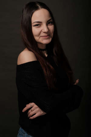 lowkey portrait of beautiful woman with closed eyes over dark backgroundの写真素材
