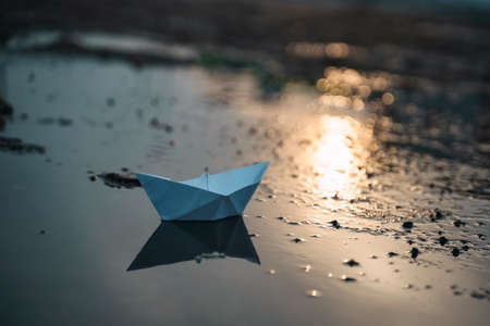 Paper boat on beach on sunset time artの写真素材