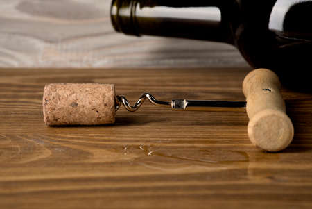 Red wine bottle on a wooden background artの写真素材
