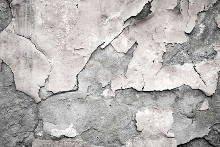 Fragment of the old wall with decaying and fallen off plaster art