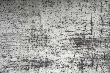 Abstract old scratched smoked metal texture with shaded edges, grunge background art.の写真素材