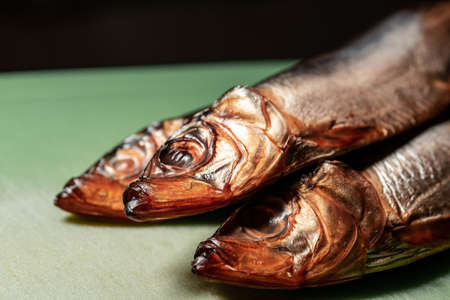 Smoked Baltic herring with dill on a black background. Copy space for your text.の写真素材