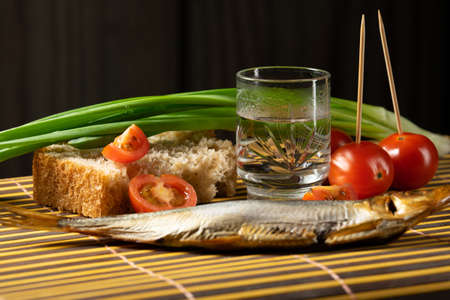 still life alcoholic vodka fish tomato green onionsの写真素材