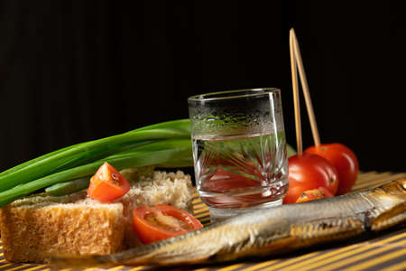 still life alcoholic vodka fish tomato green onionsの写真素材
