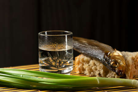 still alcoholic vodka fish fresh bread green onionsの写真素材