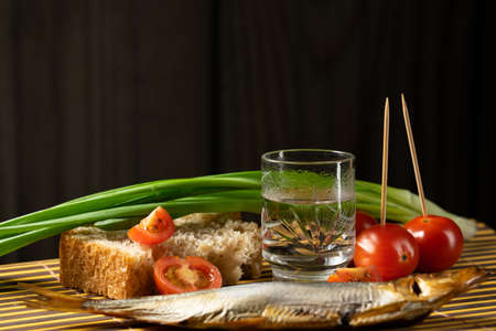 still life alcoholic vodka fish tomato green onionsの写真素材
