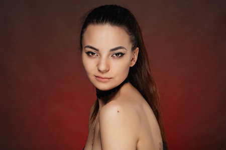 Beautiful young girl in studio on red background artの写真素材