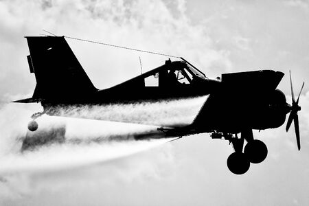 A silhouette of an airplane in the sky. Black andÂ whiteの写真素材