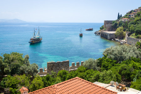 ALANYA, TURKEY - JUNE 22, 2014: Shipyard (Tersane) and the ruins of a medieval fortress (Alanya Castle) on the mountainside. Alanya. Turkey. のeditorial素材