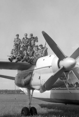 MOSCOW REGION, RUSSIA - CIRCA 1993: A group of soldiers standing on the wing of a military transport...