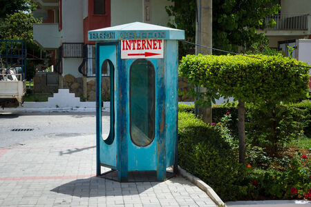 City payphone and a pointer "Internet." の写真素材