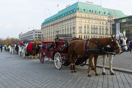 BERLIN - OCTOBER 31, 2014: Coaches on the Pariser Platz, in the background the famous luxury Hotel Adlon Kempinskiのeditorial素材