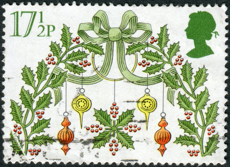 UNITED KINGDOM - CIRCA 1980: Postage stamp printed in England, Christmas Issue, shows a Traditional Decorations, Holy wreath, circa 1980のeditorial素材