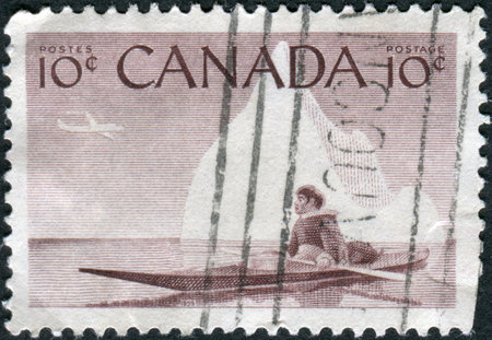 CANADA - CIRCA 1955: Postage stamp printed in Canada, shows Eskimo and Kayak, circa 1955のeditorial素材