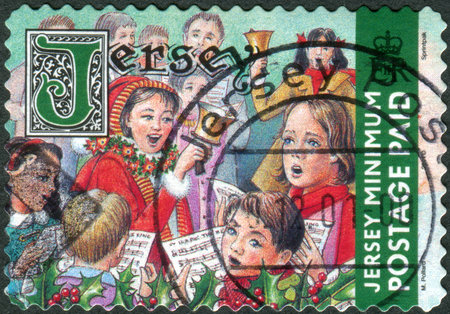 JERSEY - CIRCA 2001: Postage stamp printed in Jersey (Crown dependencies of the British Crown), Christmas Issue, shows children sing Christmas songs, circa 2001のeditorial素材