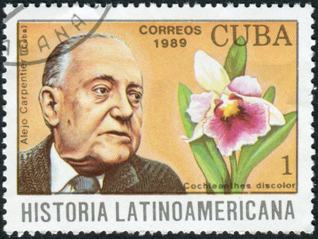 CUBA - CIRCA 1989: Postage stamp printed in Cuba, shows Cuban writer Alejo Carpentier and orchid Cochleanthes discolor, circa 1989のeditorial素材