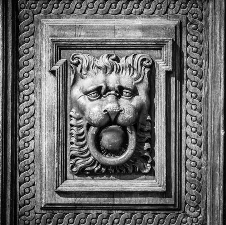 Woodcarving. Decoration vintage gate of the Old Town Hall. Prague. Black and white. Vignetting. Stylization.のeditorial素材
