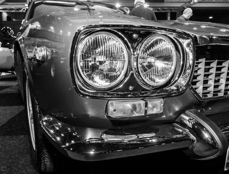 MAASTRICHT, NETHERLANDS - JANUARY 09, 2015: Headlamp of a sports car Maserati Mexico 4.2 (Tipo AM112), 1972. Black and white. International Exhibition InterClassics & Topmobiel 2015のeditorial素材