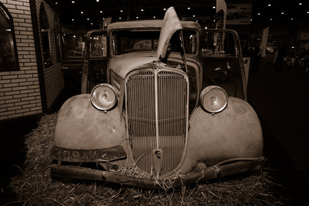 MAASTRICHT, NETHERLANDS - JANUARY 09, 2015: Rusty body of a compact car Renault Monaquatre, 1934. Vintage toning. Sepia. International Exhibition InterClassics & Topmobiel 2015のeditorial素材