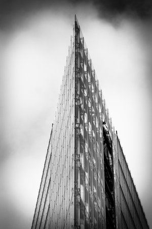 BERLIN - FEBRUARY 22, 2015: Detail of a modern building Neues Kranzler Eck on the famous shopping street - Kurfuerstendamm. Black and white. Stylization. Large grains.のeditorial素材