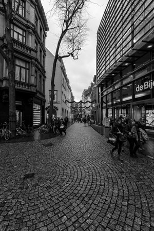 MAASTRICHT, NETHERLANDS - JANUARY 09, 2015: Old narrow street in the historic center. Black and white. Maastricht is the oldest city of the Netherlands and the capital city of the province of Limburg.のeditorial素材