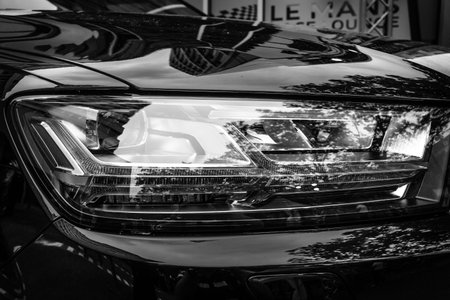 BERLIN - JUNE 14, 2015: Headlamp of a full-size luxury crossover SUV Audi Q7 3.0 TDI quattro. Black and white. The Classic Days on Kurfuerstendamm.のeditorial素材