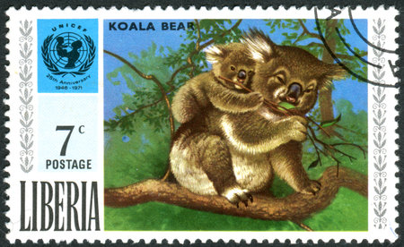 LIBERIA - CIRCA 1971: Postage stamp printed in Liberia, the 25th anniversary of UNICEF, shows Koala and UNICEF Emblem, circa 1971のeditorial素材