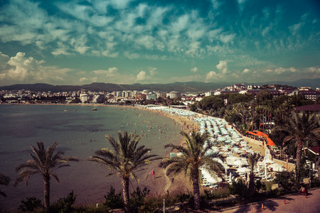 AVSALLAR, TURKEY - JUNE 30, 2015: The coastline and relax on the beach. Anatolian coast - a popular holiday destination in summer of European citizens. Vintage toning. Stylization.のeditorial素材