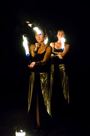 AVSALLAR, TURKEY - JUNE 30, 2015: Fire show. Evening performance on the beach for vacationers. Anatolian coast - a popular holiday destination in summer of European citizens.のeditorial素材