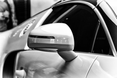 BERLIN - SEPTEMBER 04, 2012: Showroom. Detail (rear view mirror) of a Bugatti Veyron EB 16.4 is a mid-engined grand touring car. Black and white. Bugatti Veyron - the fastest car in the world.のeditorial素材