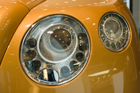 BERLIN - SEPTEMBER 04, 2012: Showroom. Headlamp of a personal luxury car Bentley New Continental GT V8. Close-up. Produced since 2013.のeditorial素材