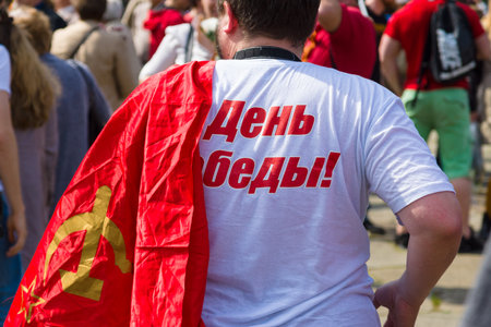 BERLIN - MAY 09, 2015: Victory Day in Treptower Park. The man with the flag of the Soviet Union.のeditorial素材