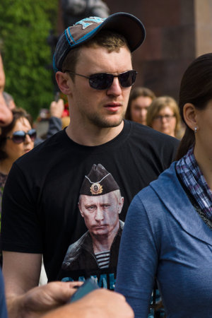 BERLIN - MAY 09, 2015: Victory Day in Treptower Park. A man in a shirt with a portrait of Russian President Vladimir Putin.のeditorial素材